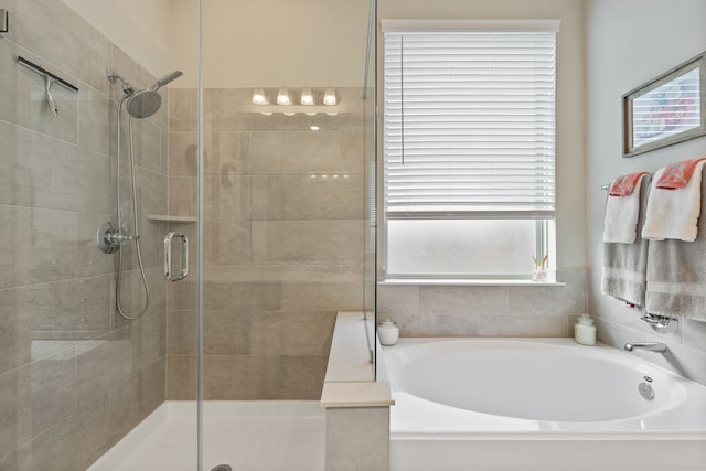 full bath featuring a bath and a shower stall