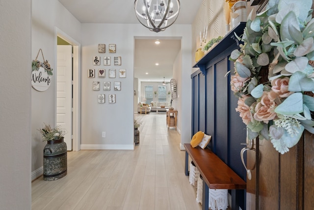 entrance foyer with light wood-style floors, recessed lighting, baseboards, and a chandelier