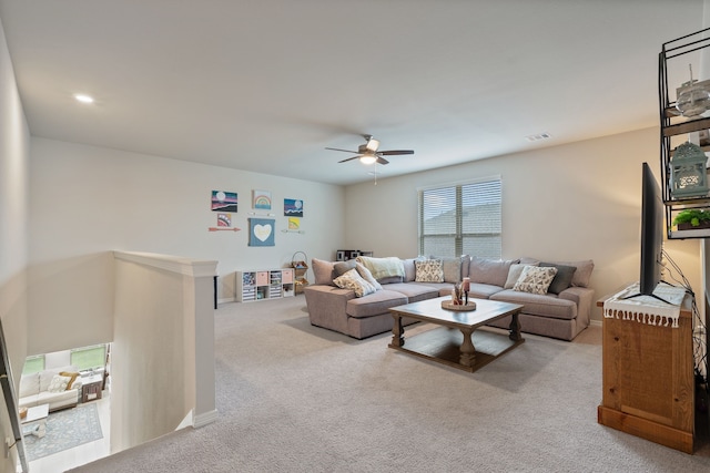 living room featuring a ceiling fan and carpet