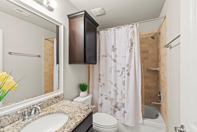bathroom with vanity, shower / tub combo, toilet, and visible vents