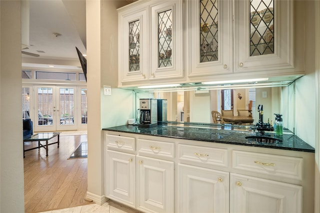 8010 Fonthill Dr, Spring, TX 77379 - bar featuring french doors and light wood-style flooring