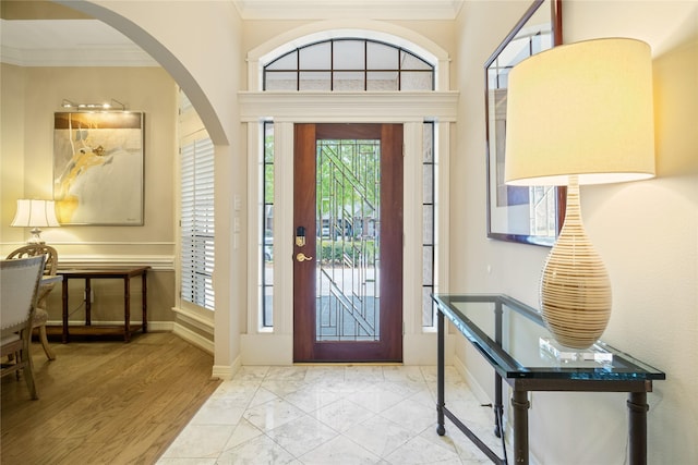 8010 Fonthill Dr, Spring, TX 77379 - foyer entrance featuring crown molding, arched walkways, baseboards, and marble finish floor