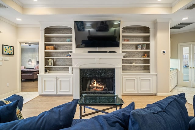 8010 Fonthill Dr, Spring, TX 77379 - living room featuring light wood-style floors, ornamental molding, a tray ceiling, and visible vents