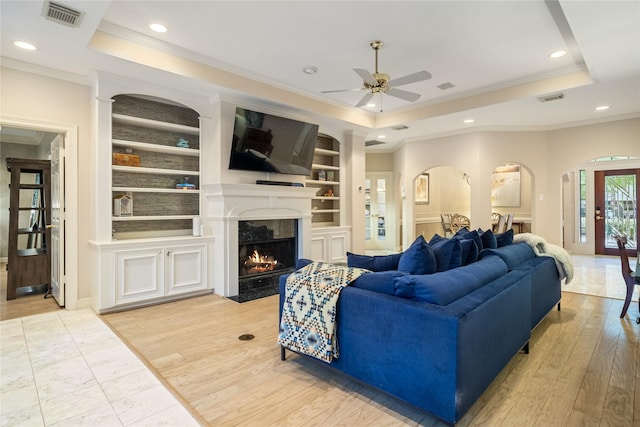 8010 Fonthill Dr, Spring, TX 77379 - living area with visible vents, ornamental molding, a tray ceiling, and built in shelves