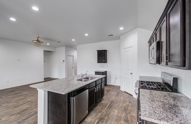 kitchen featuring dark wood-type flooring, a sink, appliances with stainless steel finishes, and recessed lighting