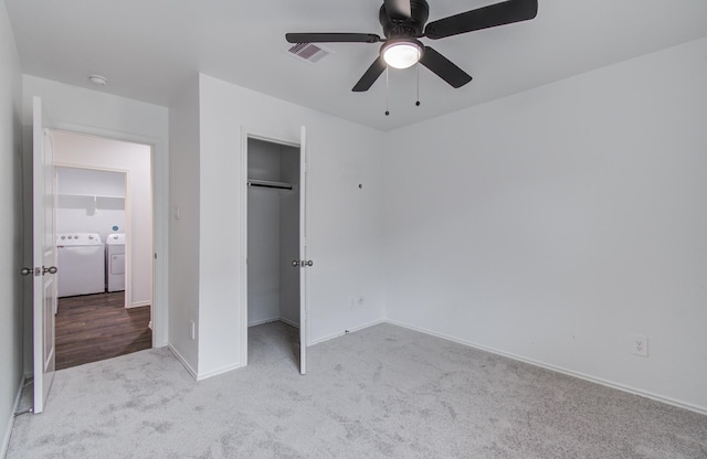 unfurnished bedroom featuring separate washer and dryer, carpet, baseboards, visible vents, and a closet