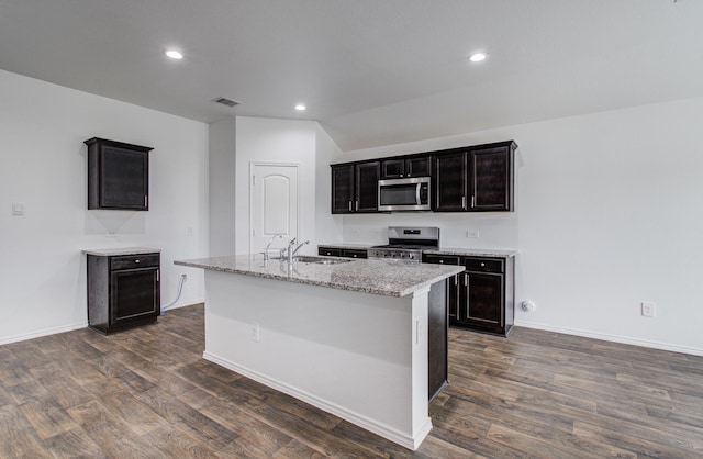 kitchen with a sink, stainless steel appliances, dark wood-style floors, and visible vents