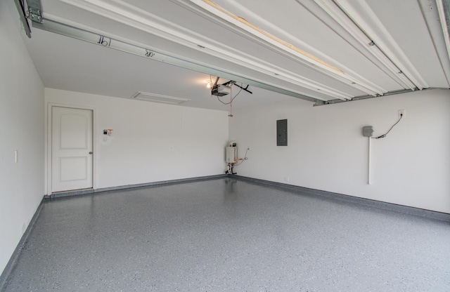 garage featuring baseboards, a garage door opener, and electric panel