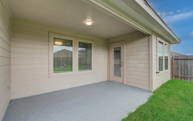 view of patio featuring fence