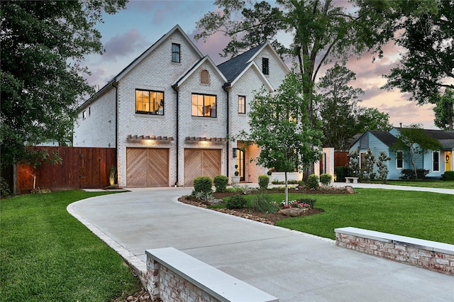 view of front of property featuring concrete driveway, a garage, fence, and brick siding
