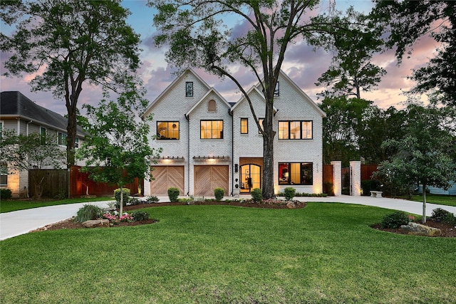 view of front of house with curved driveway, an attached garage, and fence