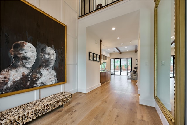 hall featuring light wood-type flooring, baseboards, and recessed lighting