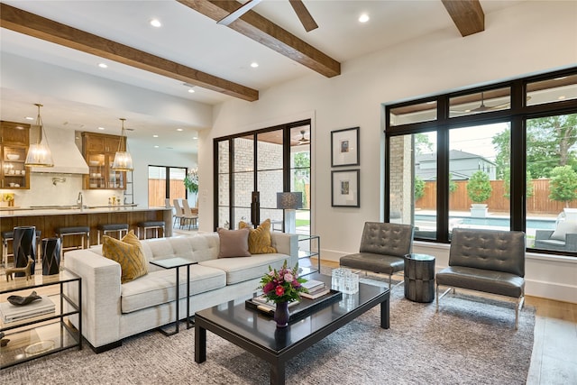 living room with light wood-type flooring, beamed ceiling, and recessed lighting