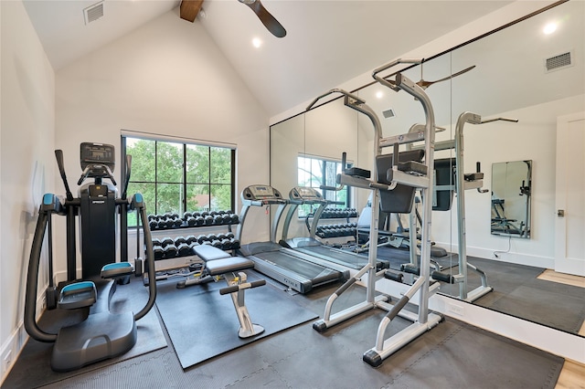 workout area with visible vents, baseboards, a ceiling fan, and high vaulted ceiling