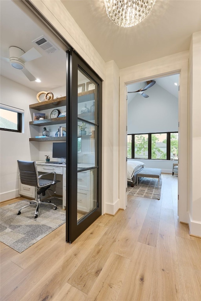 office area featuring baseboards, a ceiling fan, visible vents, and light wood-style floors
