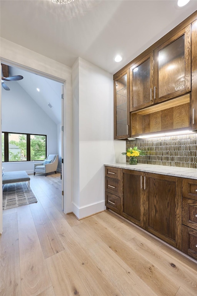 bar featuring lofted ceiling, recessed lighting, a ceiling fan, baseboards, and light wood-style floors