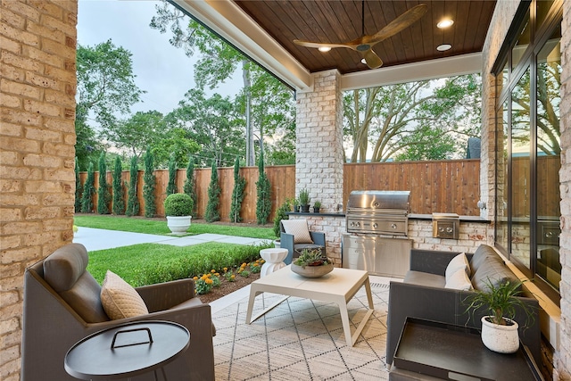 view of patio / terrace featuring area for grilling, a ceiling fan, and a fenced backyard