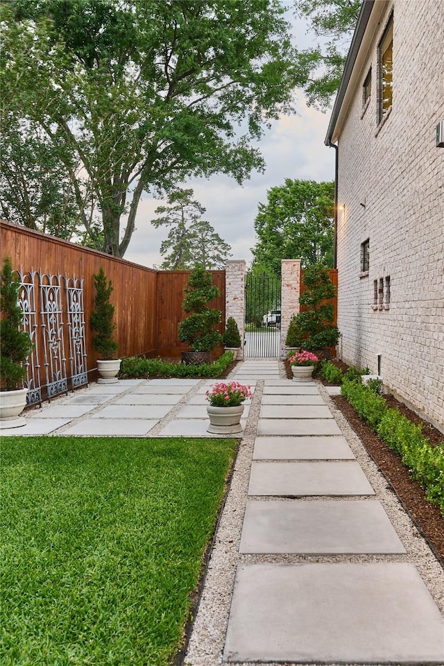 view of yard featuring fence and a gate