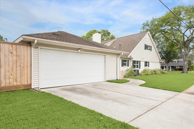 view of front facade with concrete driveway, a chimney, a front lawn, and a garage