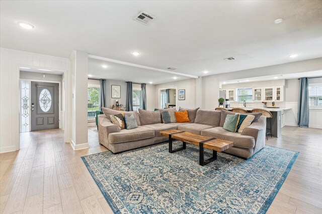living room with light wood-style floors, recessed lighting, and visible vents