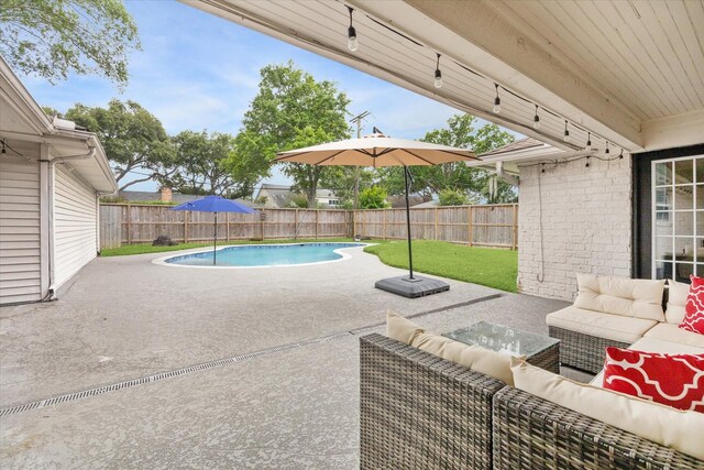 view of pool featuring a lawn, outdoor lounge area, a fenced backyard, and a patio area