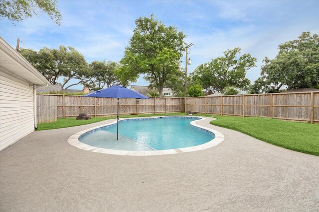 view of pool with a lawn, a fenced in pool, a patio, and a fenced backyard