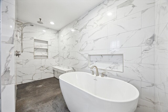 bathroom featuring recessed lighting, a freestanding tub, tile walls, and a marble finish shower