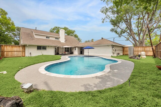 view of swimming pool with a lawn, a patio, a fenced in pool, and a fenced backyard