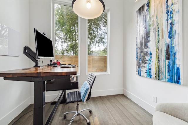 office featuring baseboards and wood finished floors