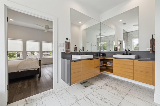 ensuite bathroom with a sink, marble finish floor, and ceiling fan