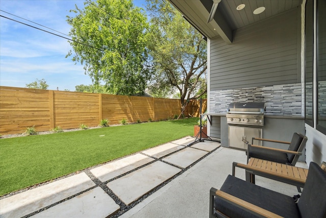 view of patio / terrace with a fenced backyard and a grill