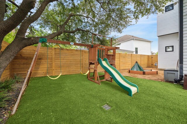 view of play area featuring a fenced backyard and a lawn