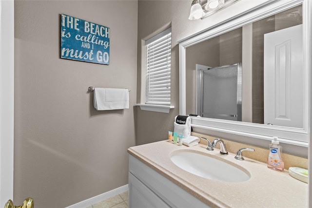 full bathroom featuring tile patterned floors, a shower stall, baseboards, and vanity