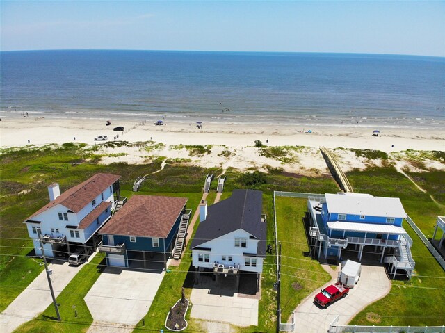 bird's eye view with a water view and a beach view
