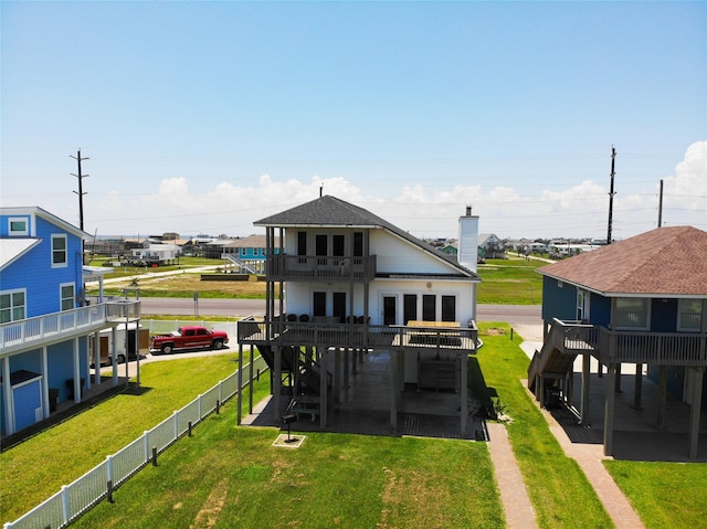 rear view of property with a wooden deck, stairway, a fenced backyard, a balcony, and a lawn