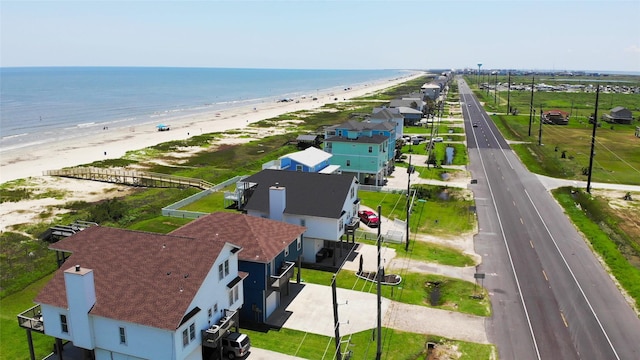 birds eye view of property featuring a beach view and a water view