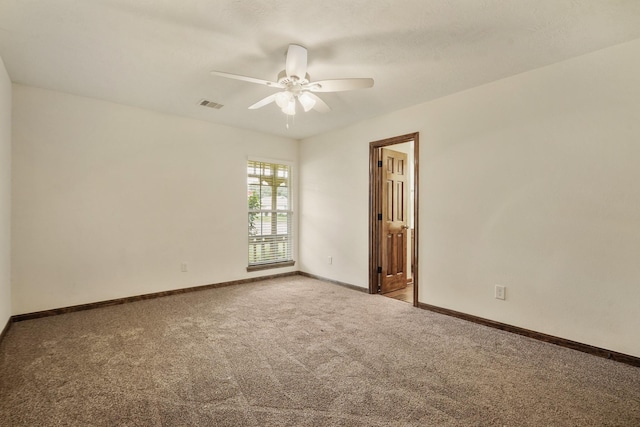 unfurnished room featuring ceiling fan, visible vents, baseboards, and carpet