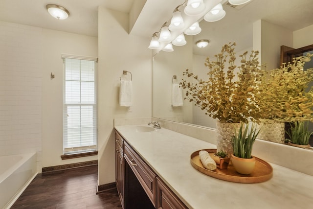 bathroom with vanity, baseboards, and wood finished floors