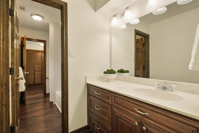 bathroom with visible vents, wood finished floors, and vanity