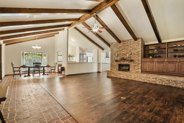 living area with a brick fireplace, vaulted ceiling with beams, ceiling fan with notable chandelier, and wood finished floors
