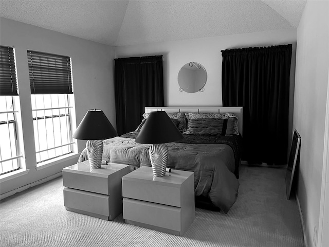 bedroom with a textured ceiling and light colored carpet