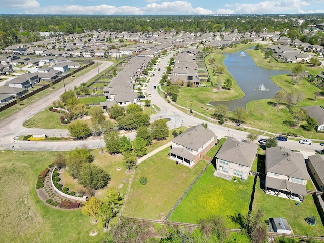 drone / aerial view with a water view and a residential view