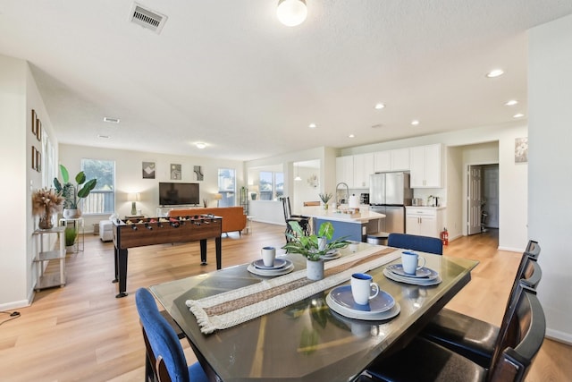 dining space featuring light wood-style floors, recessed lighting, baseboards, and visible vents