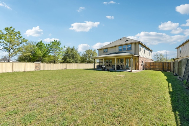rear view of property featuring a fenced backyard, a patio, a lawn, and brick siding