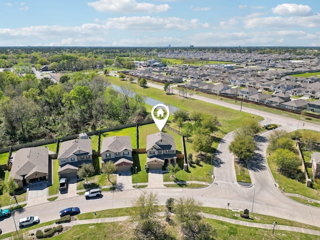 drone / aerial view with a water view and a residential view