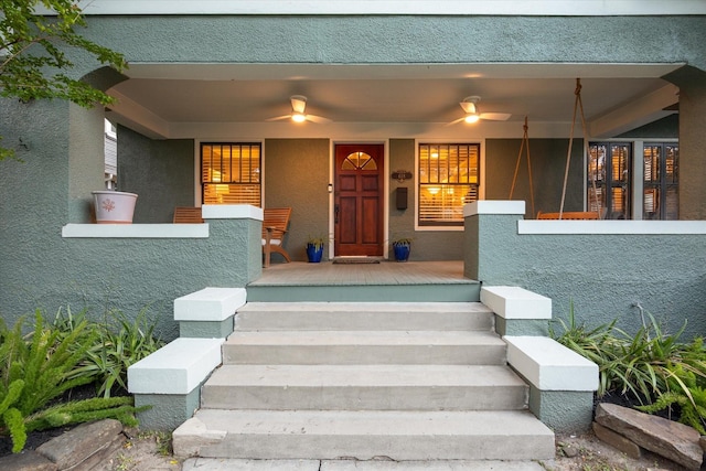 doorway to property with stucco siding and a porch