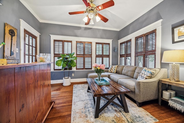 living room with baseboards, ceiling fan, ornamental molding, and wood finished floors