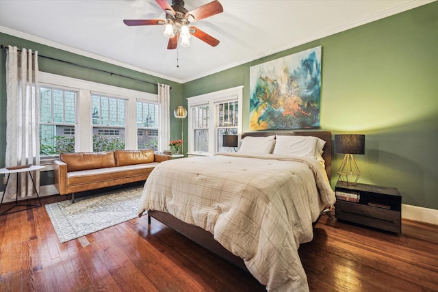 bedroom featuring crown molding, baseboards, ceiling fan, and hardwood / wood-style flooring