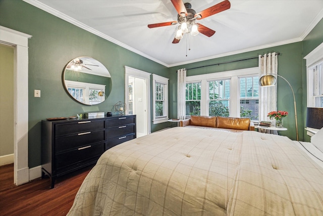 bedroom with baseboards, ornamental molding, dark wood-style flooring, and a ceiling fan