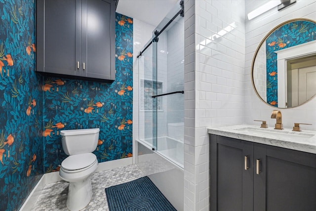 bathroom featuring toilet, baseboards, wallpapered walls, and vanity